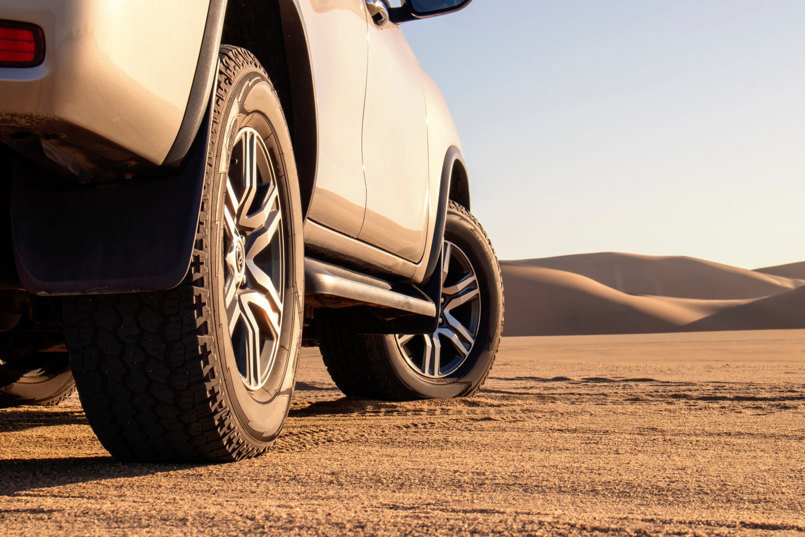 A,Close-up,Of,A,Grey,Car,In,The,Sand,Of