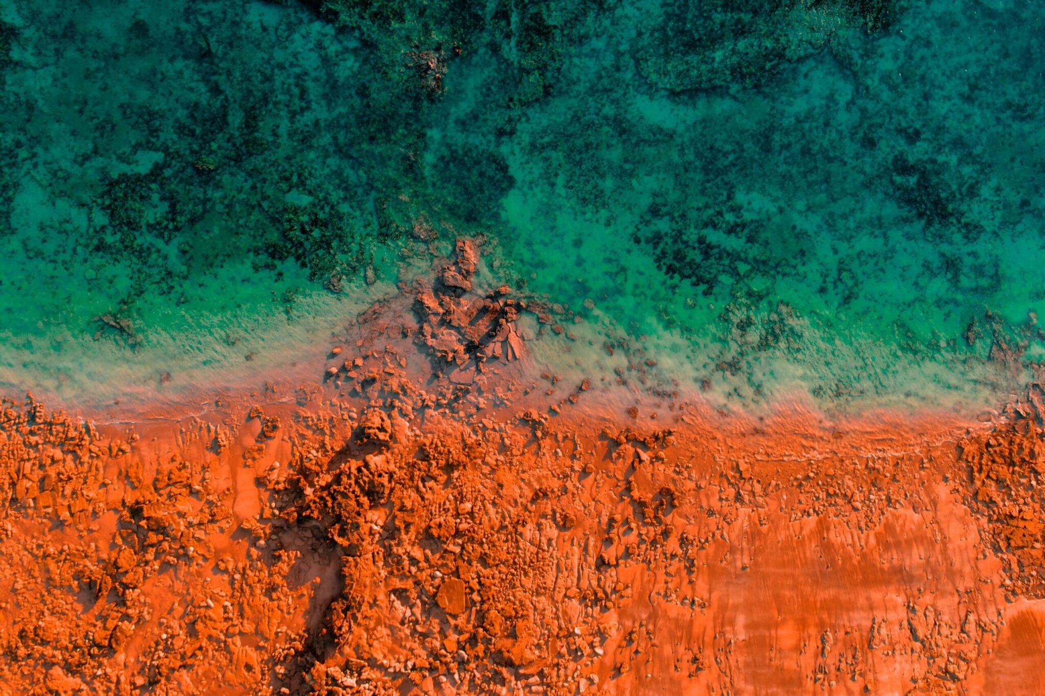 Aerial,Photo,Of,Turquoise,Ocean,Water,And,Red,Rock,Cliffs,