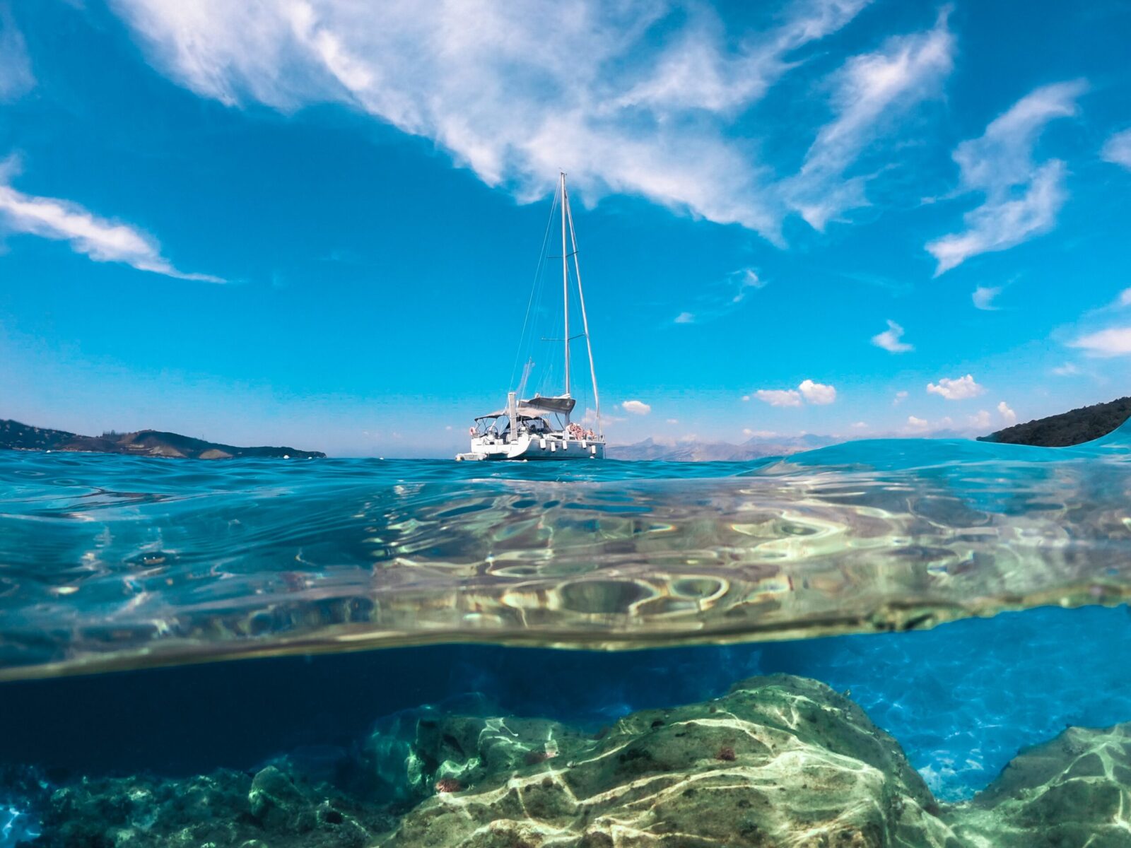 Split,View,Of,Sky,,Sea,,Boat,And,Rocks
