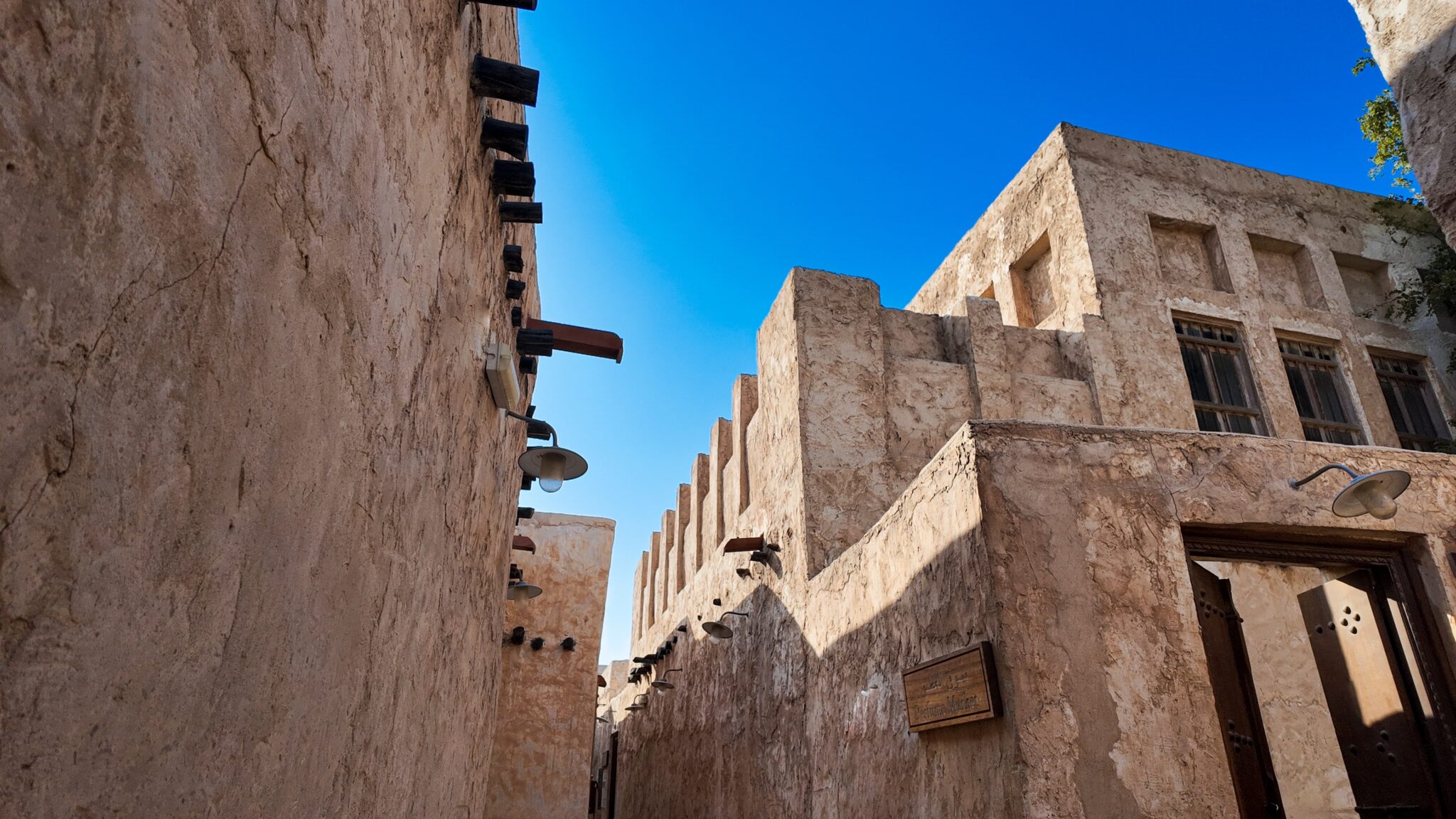 Traditional,Souq,Al,Wakrah,,Qatar,Buildings,With,Wooden,Signage,,Lamps,
