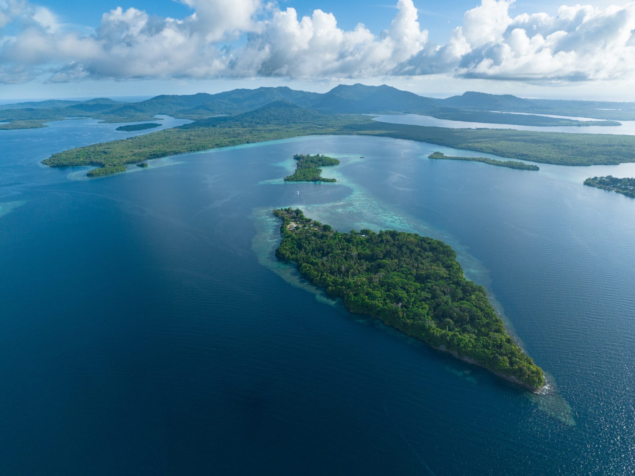 Lush,,Tropical,Islands,Are,Fringed,By,Robust,Coral,Reefs,In