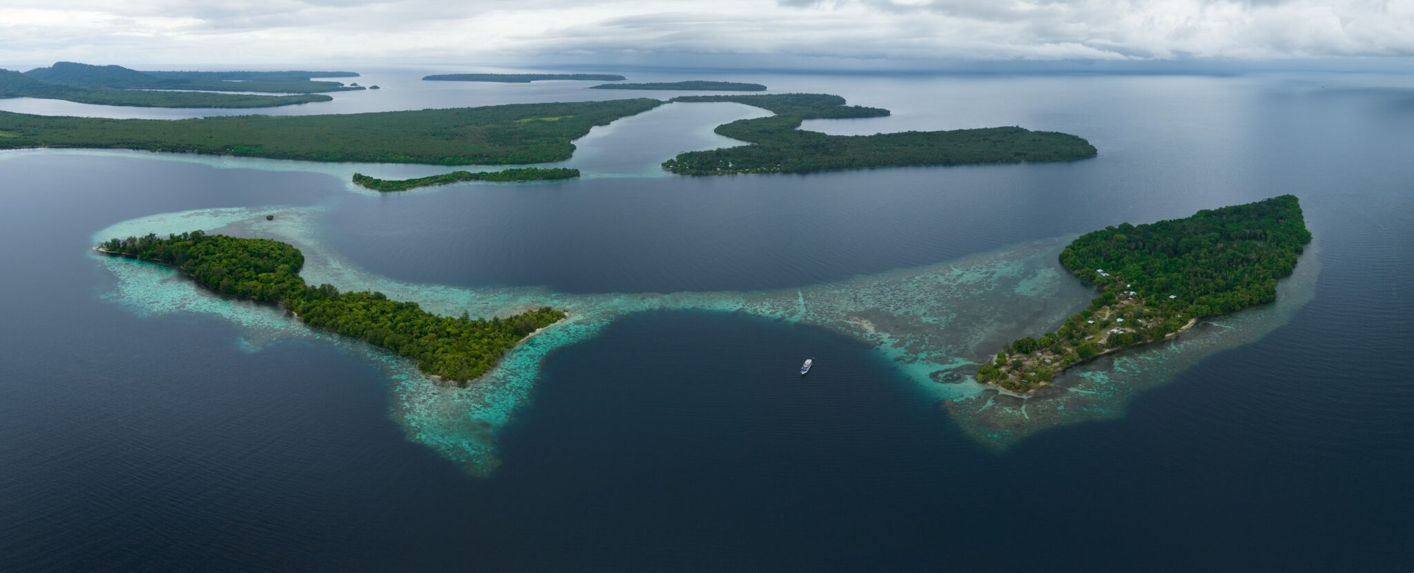 Lush,,Tropical,Islands,Are,Fringed,By,Robust,Coral,Reefs,In